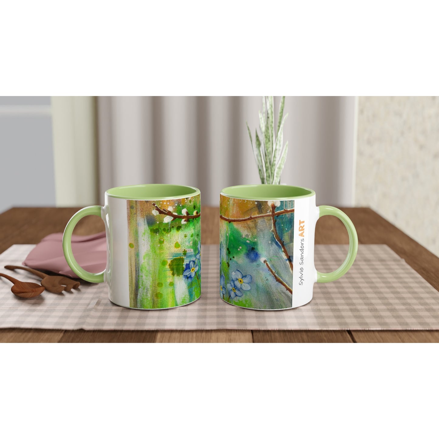 A Pair of Pussy Willow Forget Me Not Ceramic Mugs sat on chequered  cloth